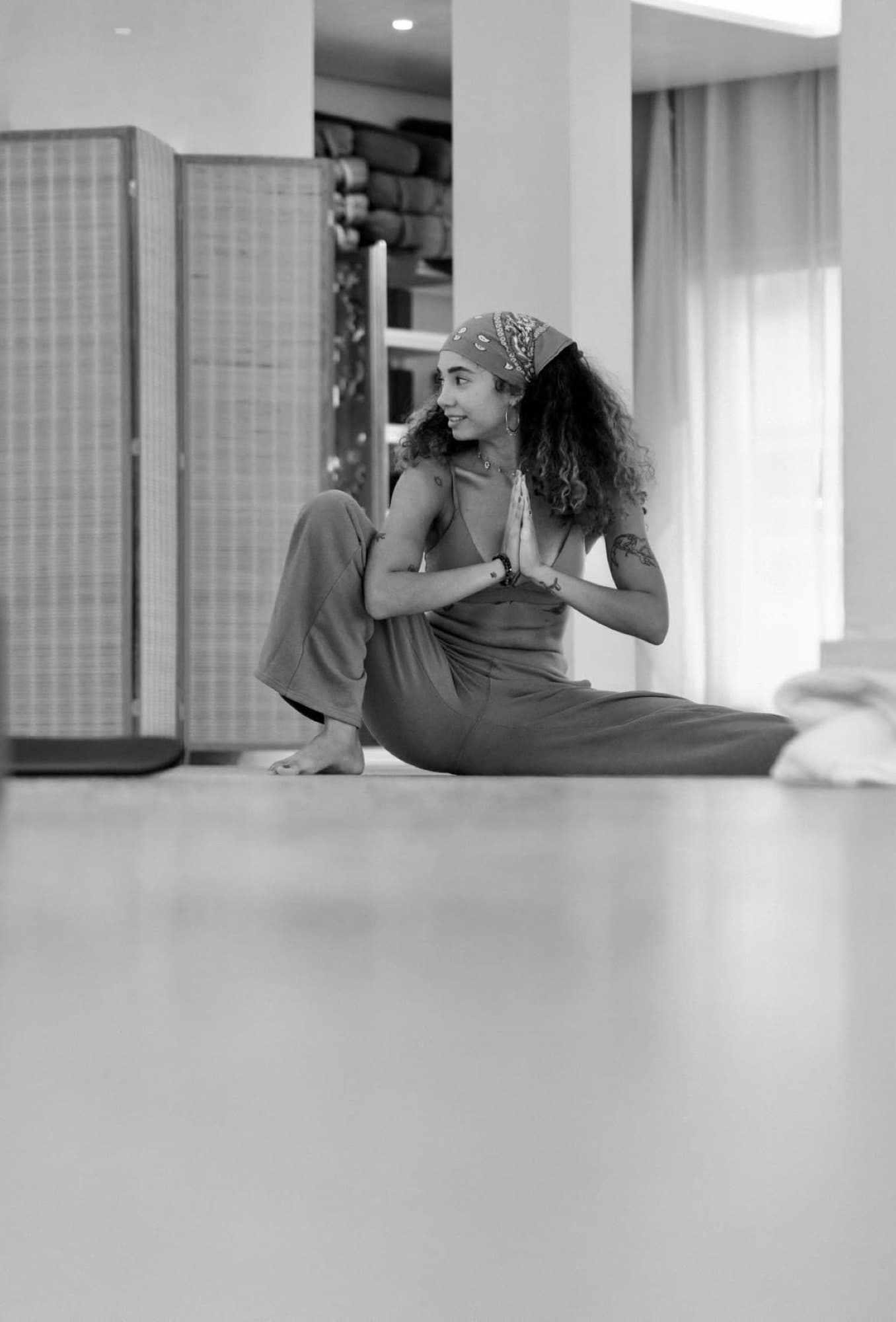 Ale seated in a twist with hands at heart center