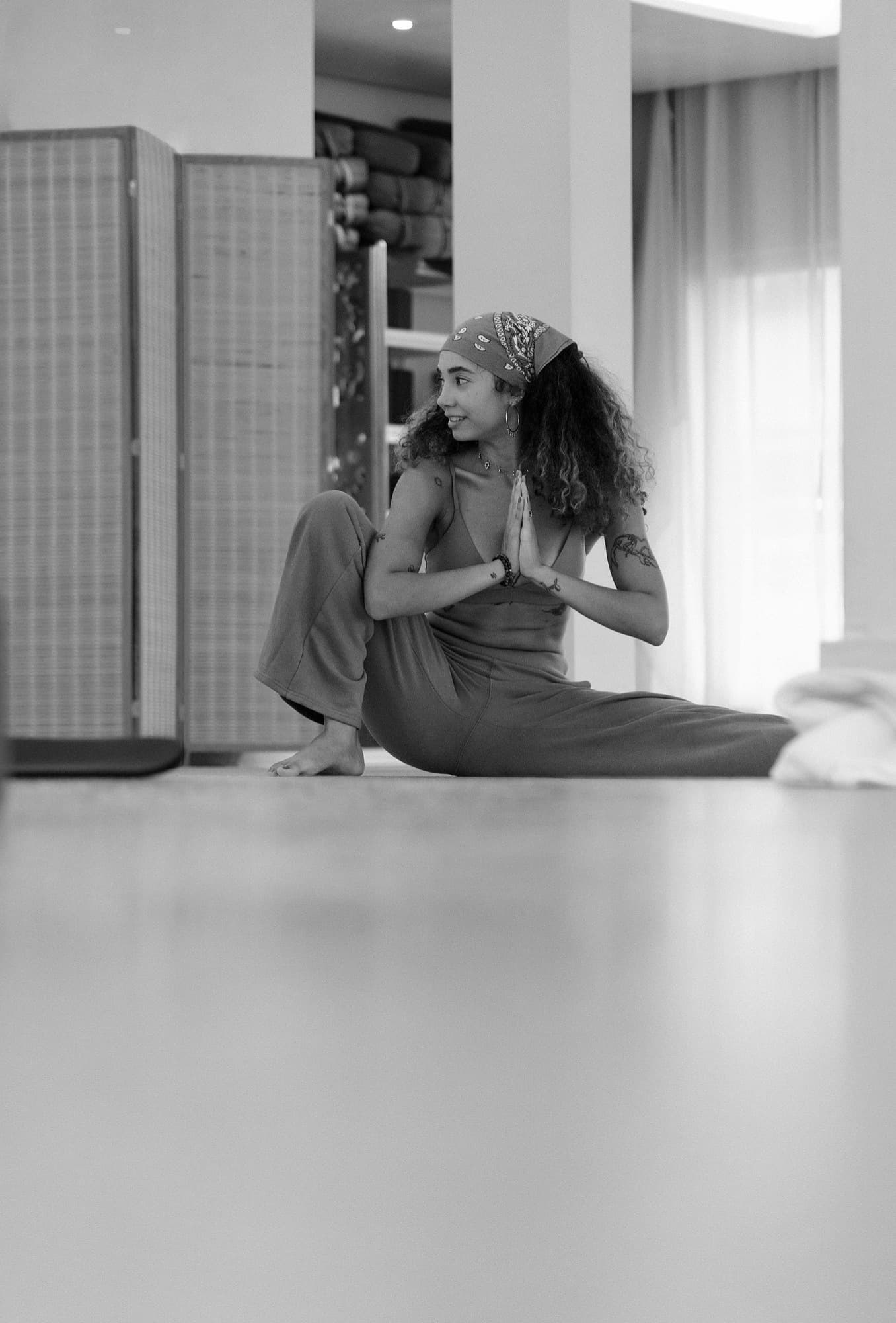 Ale in a seated twist with hands at heart